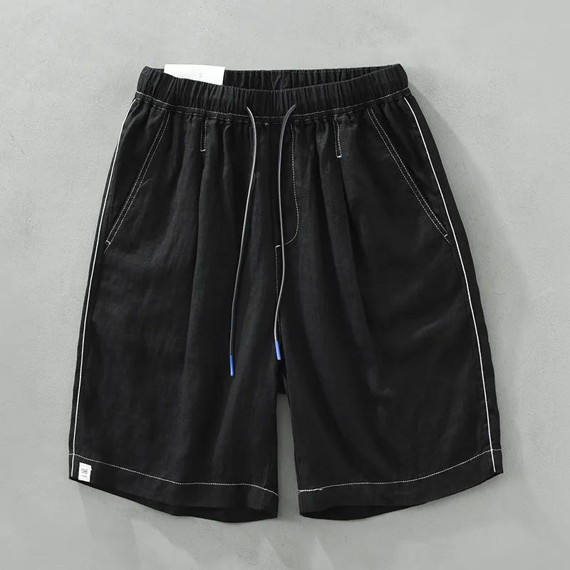 Men's loose fit linen shorts in green on a neutral background