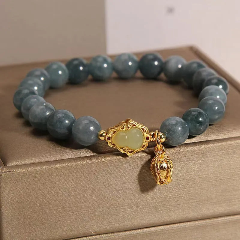 Sky blue natural stone gourd lotus flower pendant on a women's adjustable bracelet with electroplated metal.