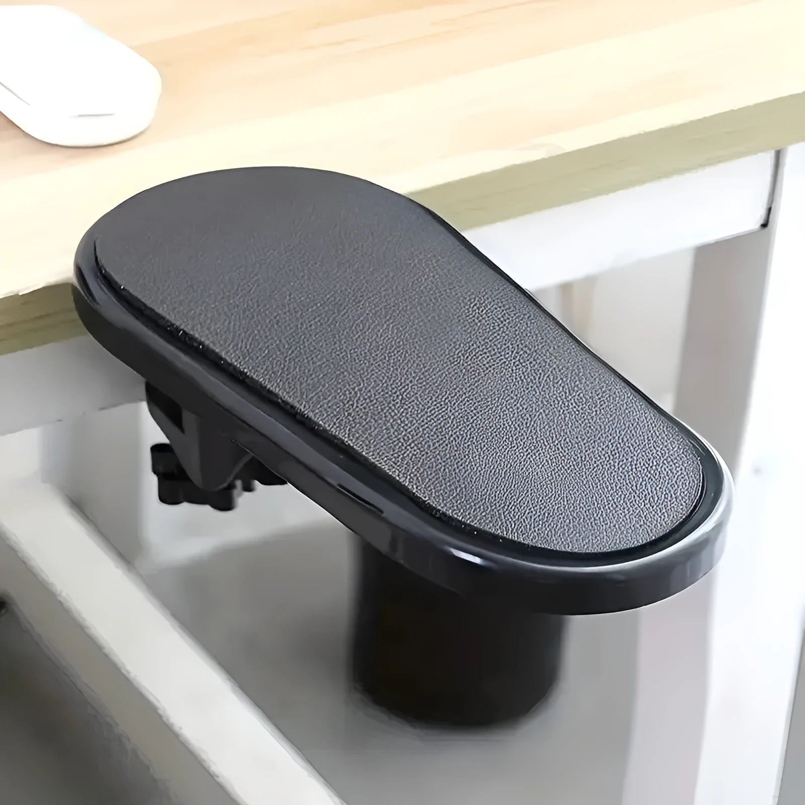 Black plastic computer hand bracket wrist support with modern simplicity style on a white desk surface