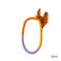 Green circular cotton rope cat toy with feathers and catnip for chewing and interactive play