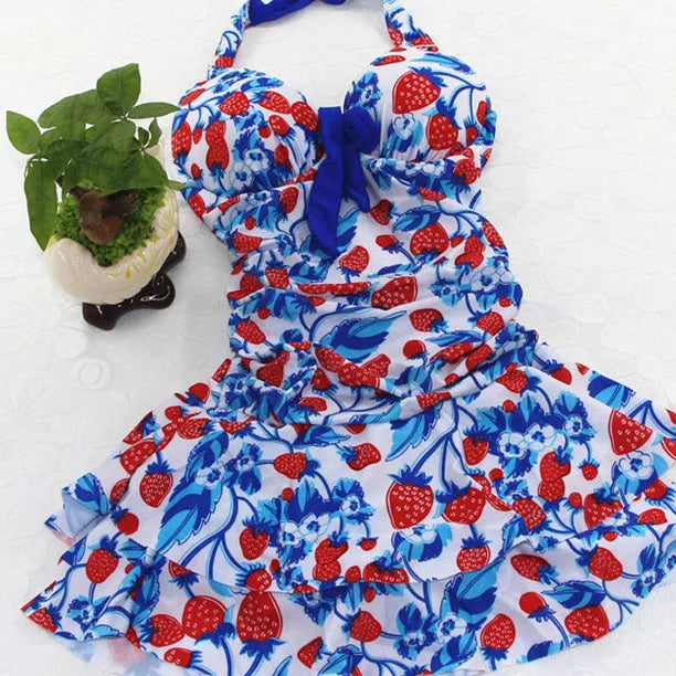 Blue strawberry print women's one-piece swimsuit with cross straps and a backless design.