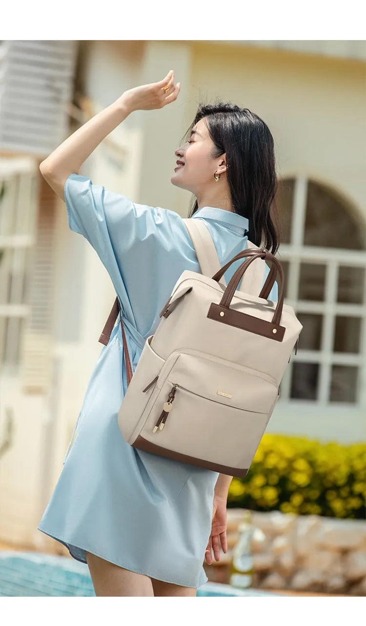 Women's large capacity backpack in apricot colour showing dimensions and adjustable shoulder strap