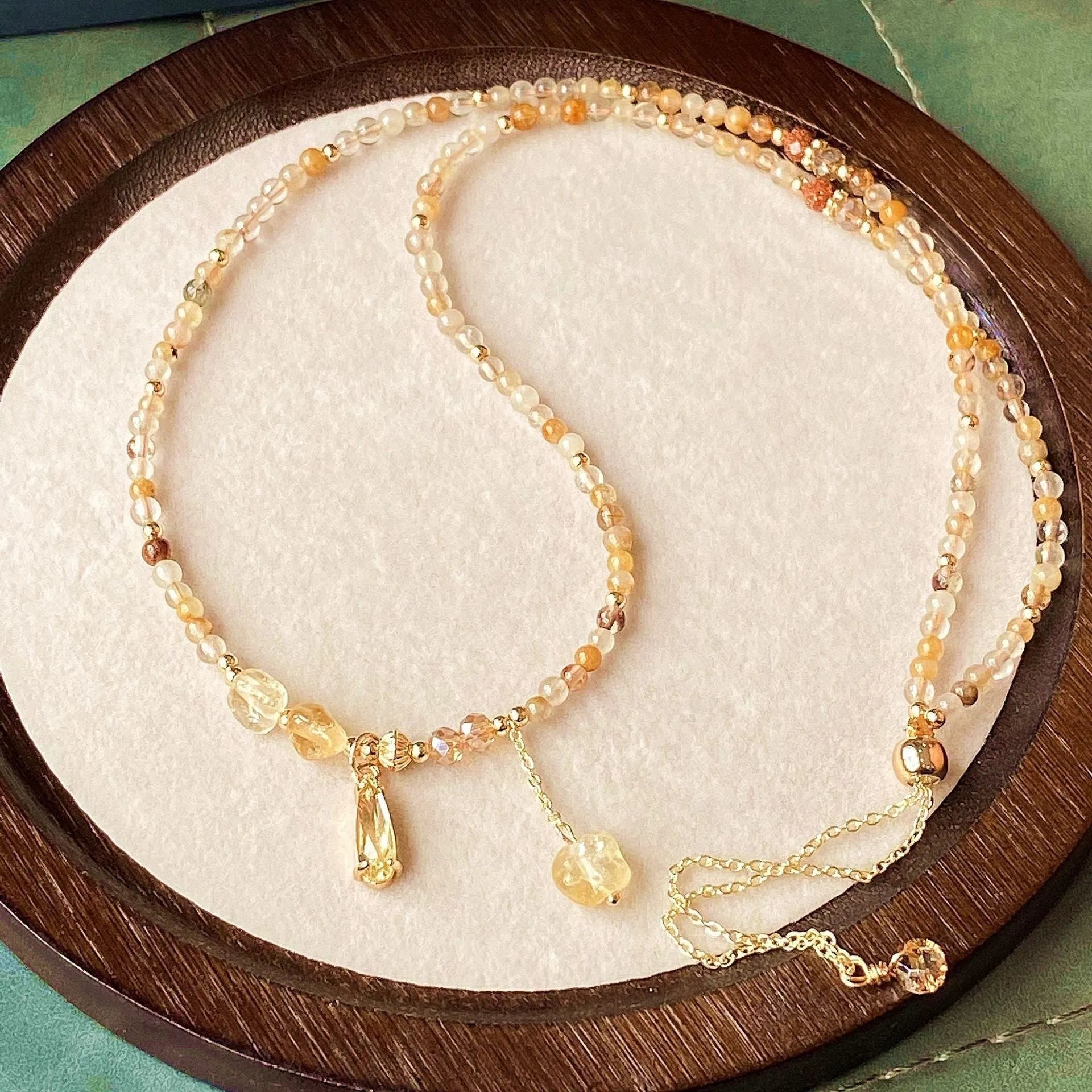 Gold tone women's bracelet with natural caramel coloured citrine crystal and Saturn decorative element