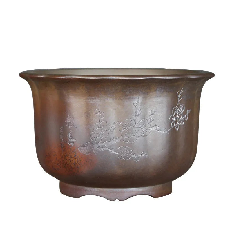 Indoor antique carved purple sand ceramic flowerpot for bonsai plants on a wooden surface.