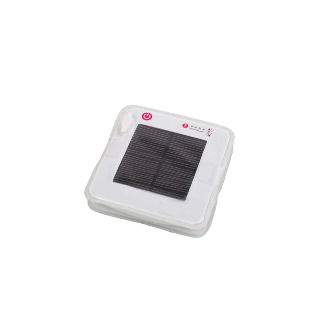 White solar inflatable waterproof camping LED lantern with handle, collapsed flat on a table