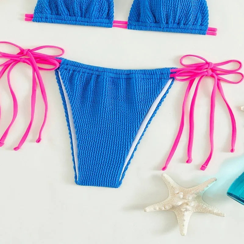 Women's black lace-up bikini swimsuit set laid flat.