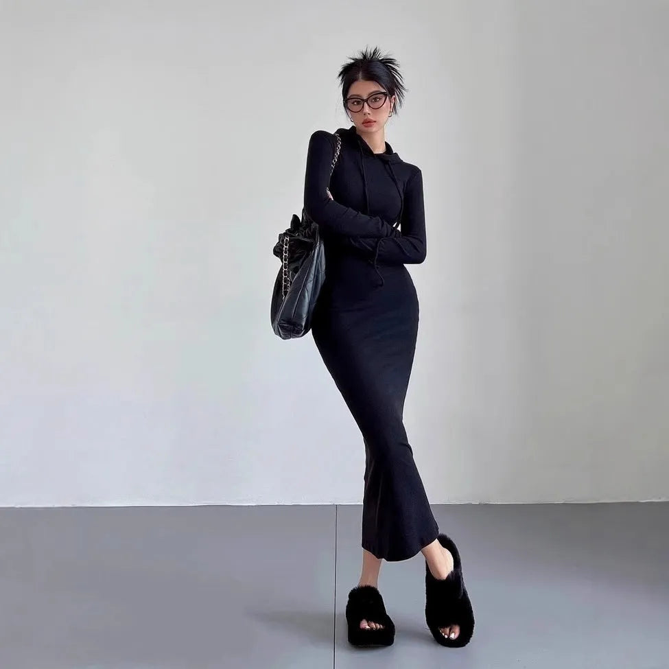 A light grey women's hooded sheath dress with long sleeves and a high waist on a model.