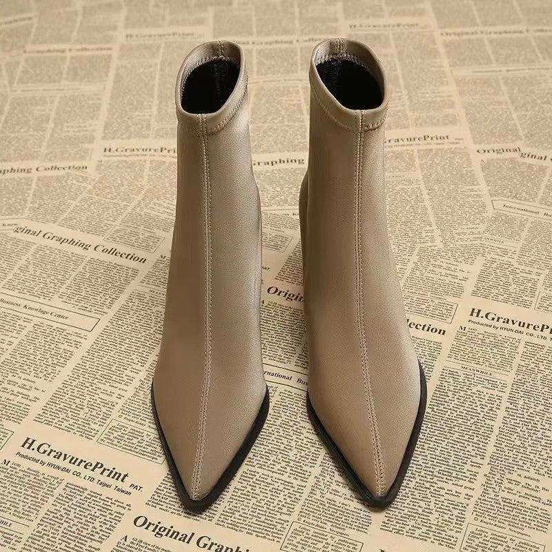 Women's khaki pointed toe Martin boots with a wedge heel on a rubber sole.