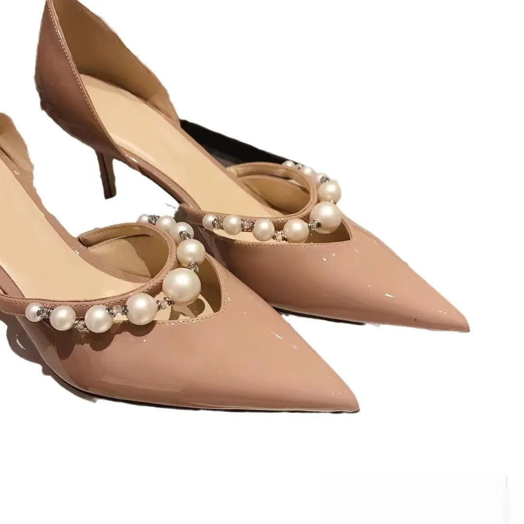 Women's black pointed patent leather stiletto high heel shoes with a glossy finish.