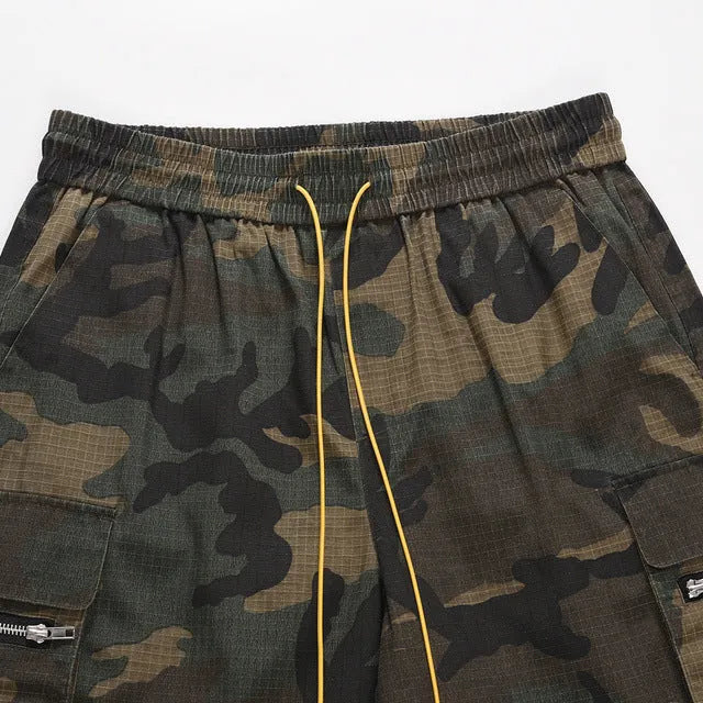 Man's green H215 camouflage cotton work shorts with multiple pockets shown in a loose fit.
