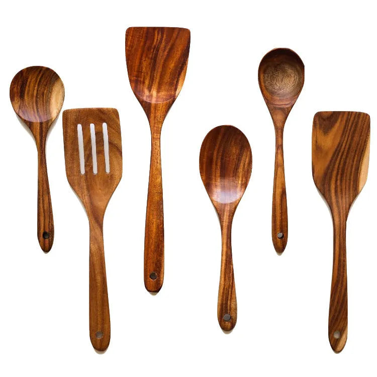Natural wood 7-piece cooking utensil set for non-stick pans on a kitchen counter.