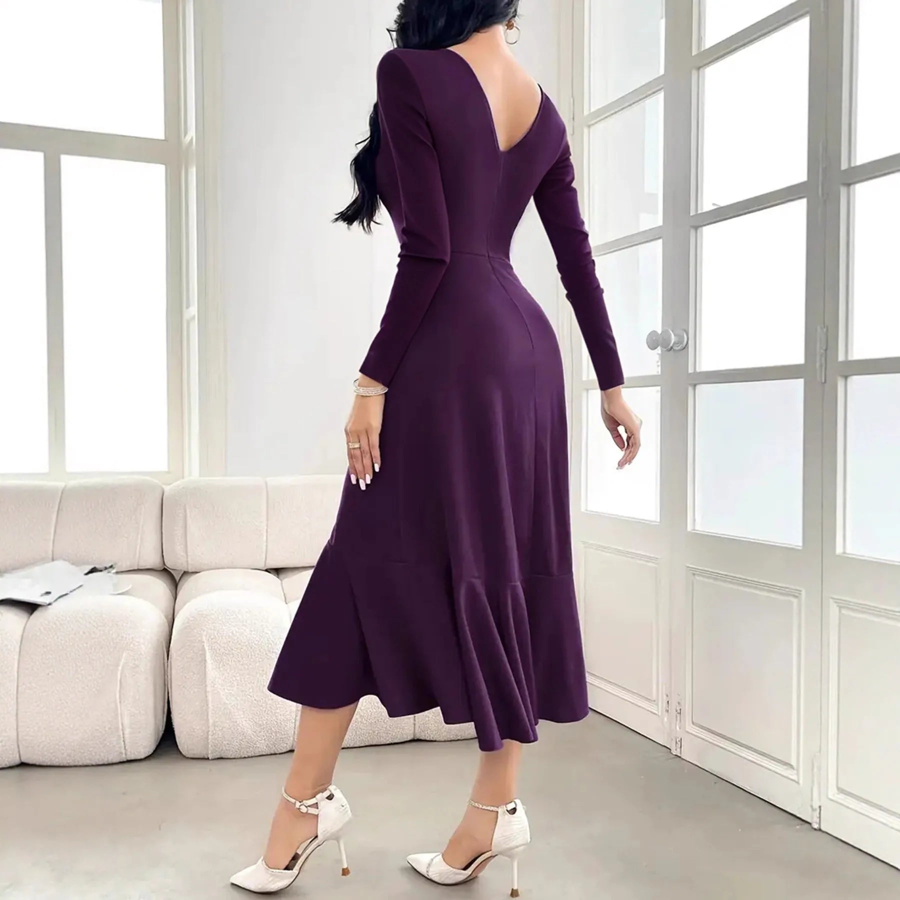 Purple women's long sleeve round neck dress with a ruffle detail on a hanger.