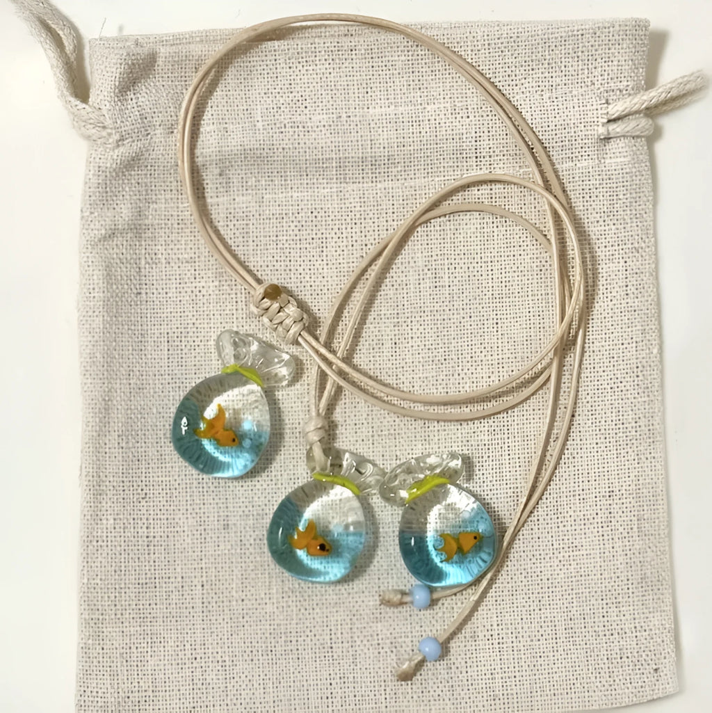 Women's joker pendant necklace with coloured glaze charm on a cotton and linen clavicle chain.