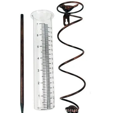 Glass rain gauge with cast iron hummingbird base for outdoor garden rainfall measurement.