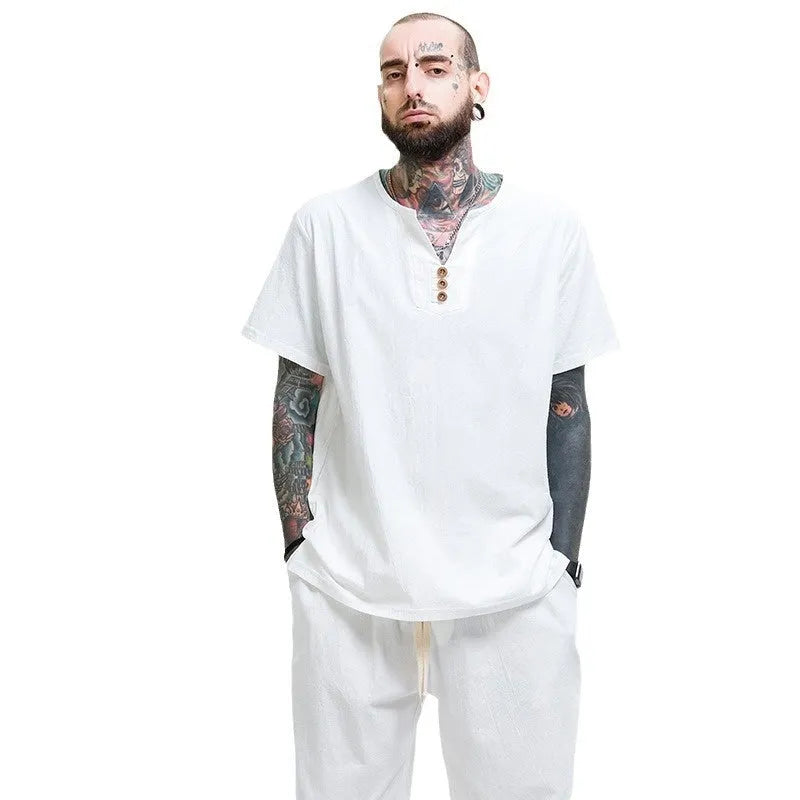 Man wearing a loose grey cotton and linen short-sleeve T-shirt, casual fit.