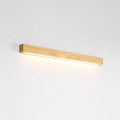 Slim, long walnut-coloured wooden strip wall lamp mounted on a plain wall.
