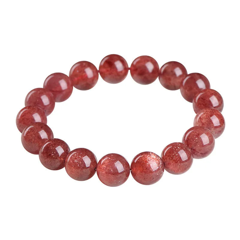 A stretch bracelet with round, pink strawberry quartz beads on an elasticated cord, shown in different size options.