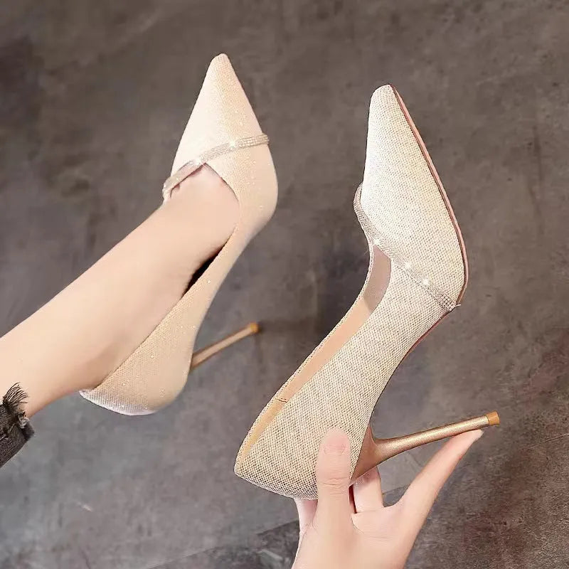 Women's black pointed toe stiletto high heels with a low-cut vamp on a white background