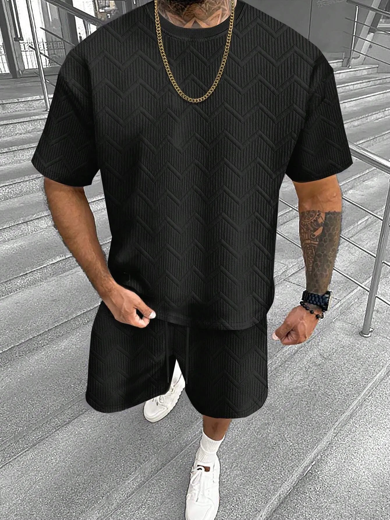 Men's short sleeve top and shorts suit in a printed polyester blend fabric.