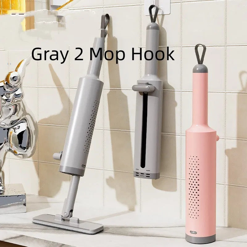 Pink rotatable self-squeeze mini flat mop with microfiber pad, shown extended to its full length.