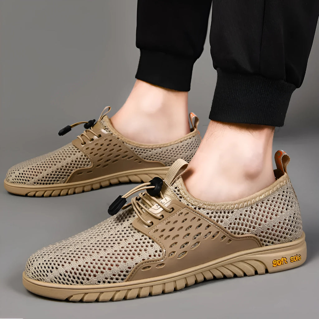 Men's black mesh casual sneaker with elastic band and rubber sole on a light background.