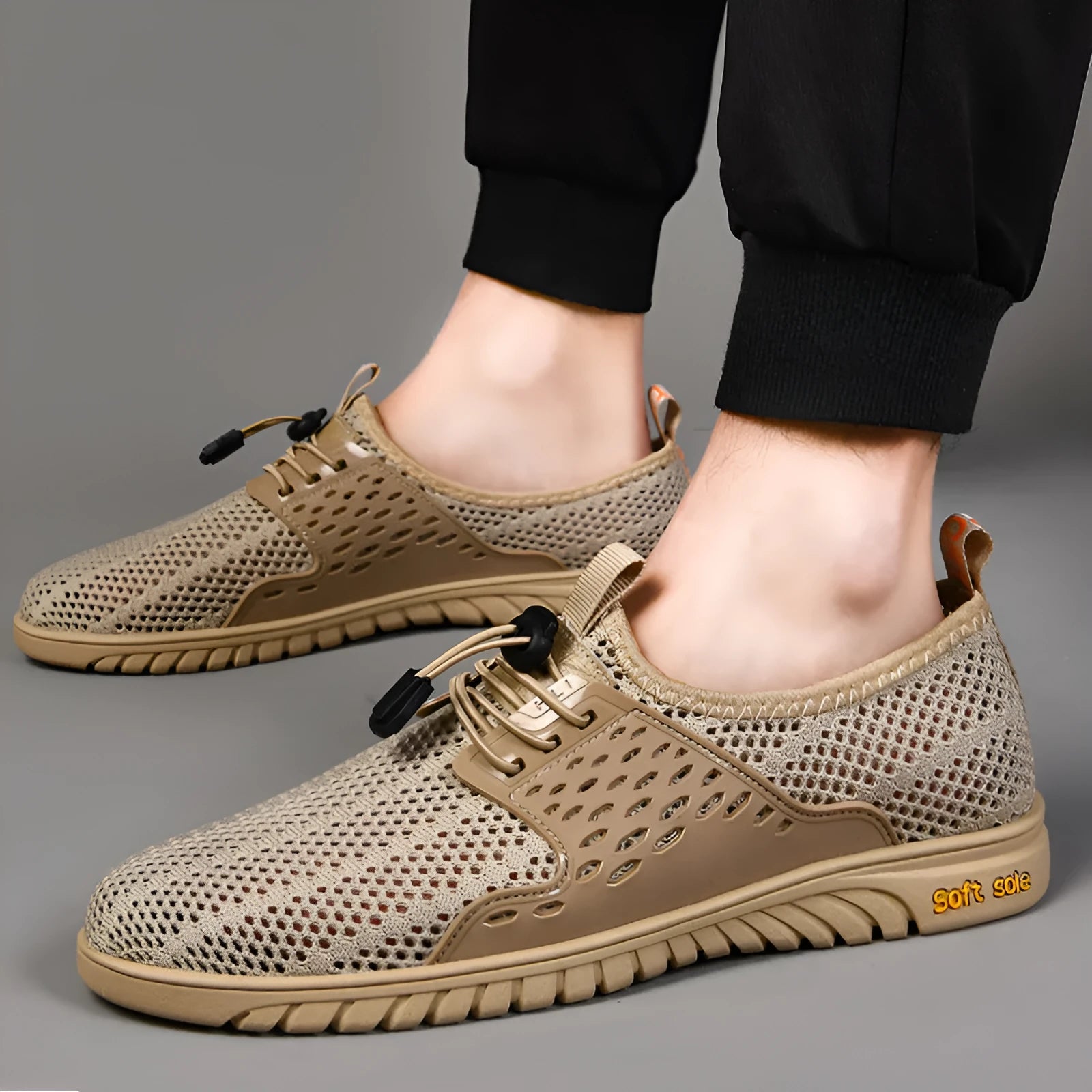 Men's black mesh casual sneaker with elastic band and rubber sole on a light background.