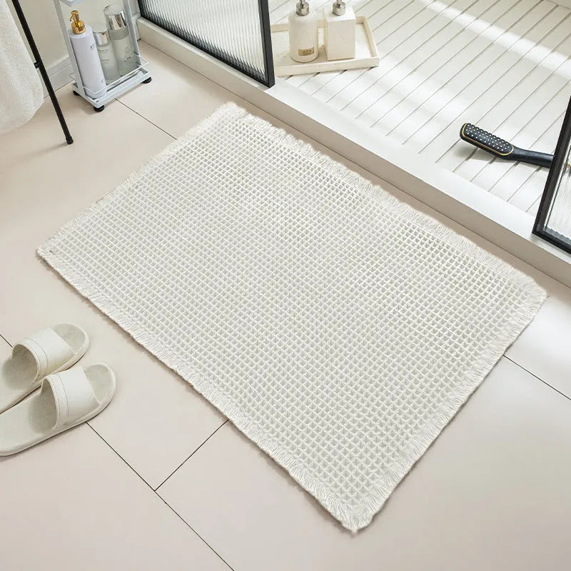 Checkered pattern non-slip absorbent bathroom floor carpet in beige colour.