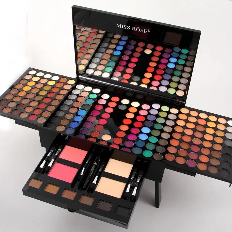 Piano-shaped makeup palette open to show 180 eyeshadows, blushes and powders inside.