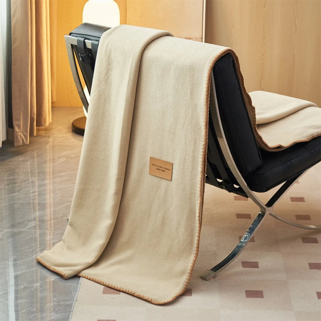 Class A Alpaca Fleecefiber blanket in solid colour, folded on a sofa, showing soft polyester texture