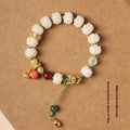 White jade Bodhi bracelet with hand-woven rope, lotus beads, and large pumpkin beads on an open ring design.