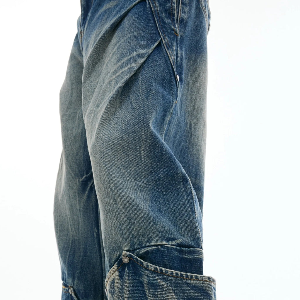 Man wearing verdant blue loose-fit retro jeans with a washed burst pattern.