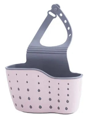 Three plastic kitchen sink storage racks in beige light blue and light pink on a draining board