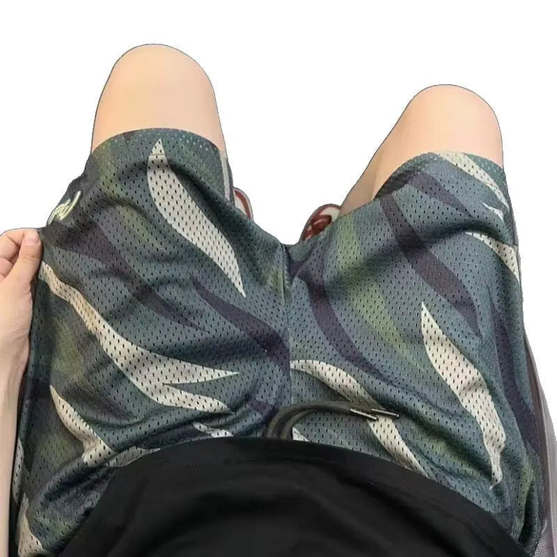 Men's straight-leg camouflage shorts in a cotton-blend fabric on a hanger.