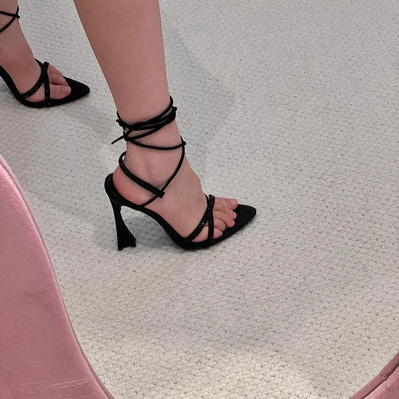 Black women's high heel sandals with satin upper, cross-band straps, and an 8cm heel.