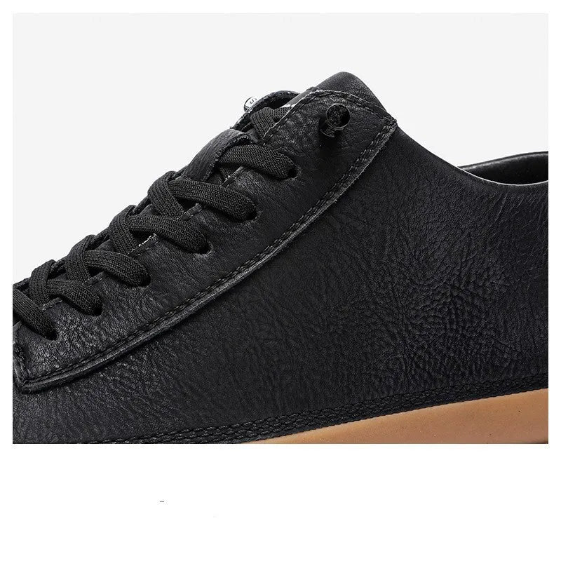Men's black and white casual leather shoes with round toe and flat rubber sole.
