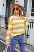 Women's loose blue striped acrylic knit sweater with long sleeves on a hanger.