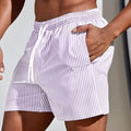 Men's loose grey mesh sports shorts on a white background, showing the short length and elasticated waistband.