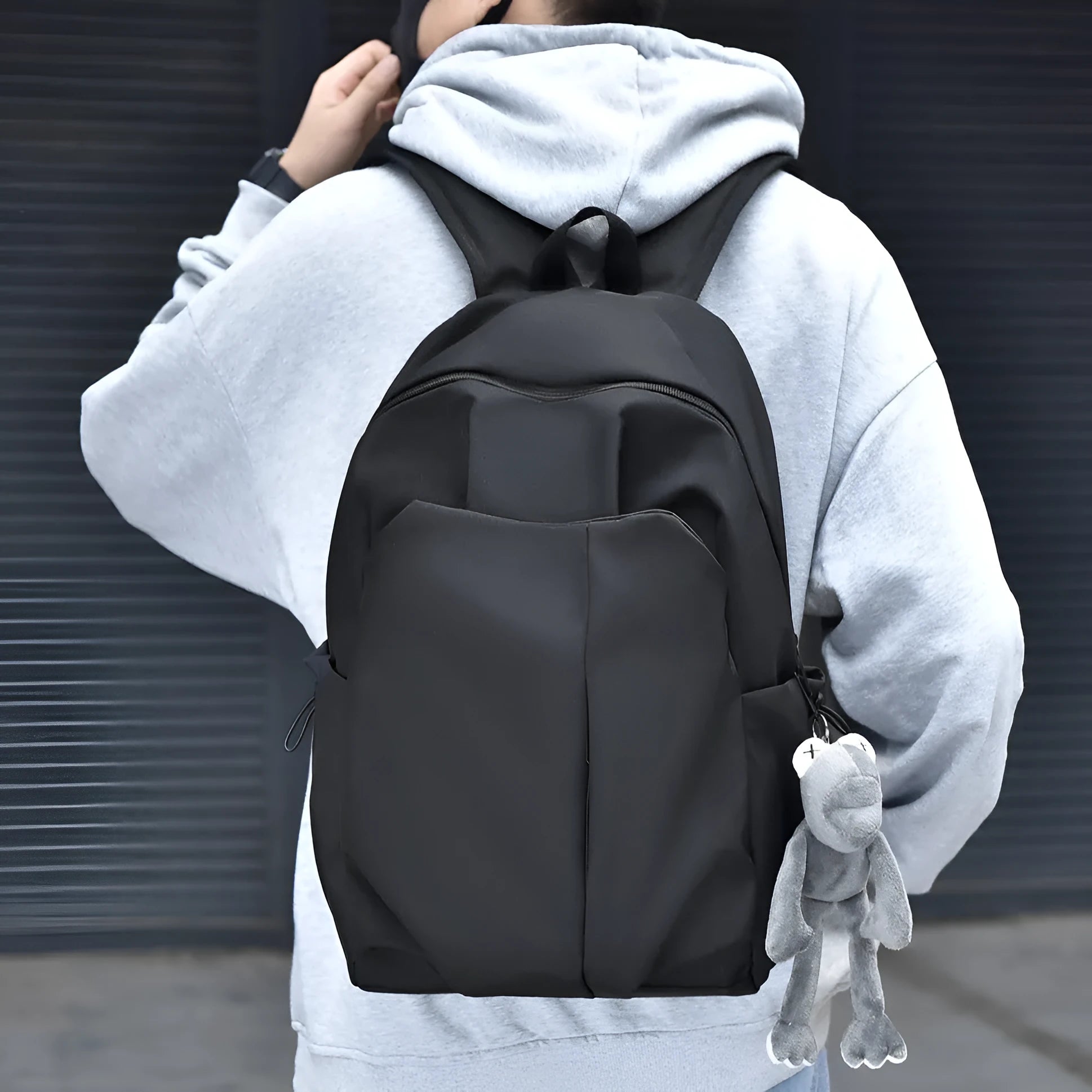 Casual large capacity Oxford cloth backpack in black with curved shoulder straps and sewing line detail