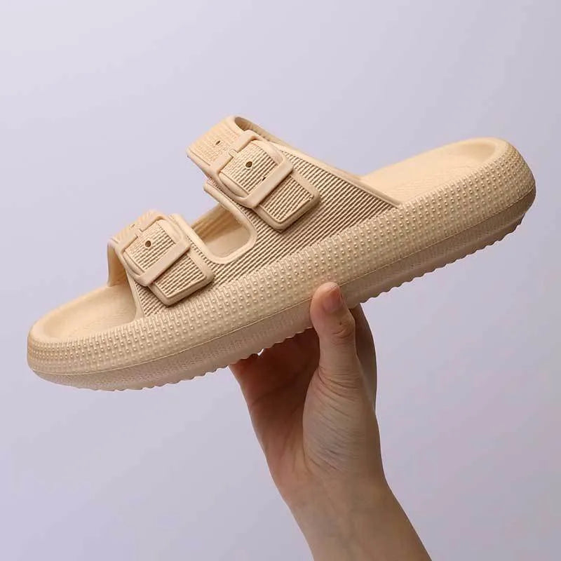 Women's beige platform slippers with buckle fastening and round toe on a flat surface