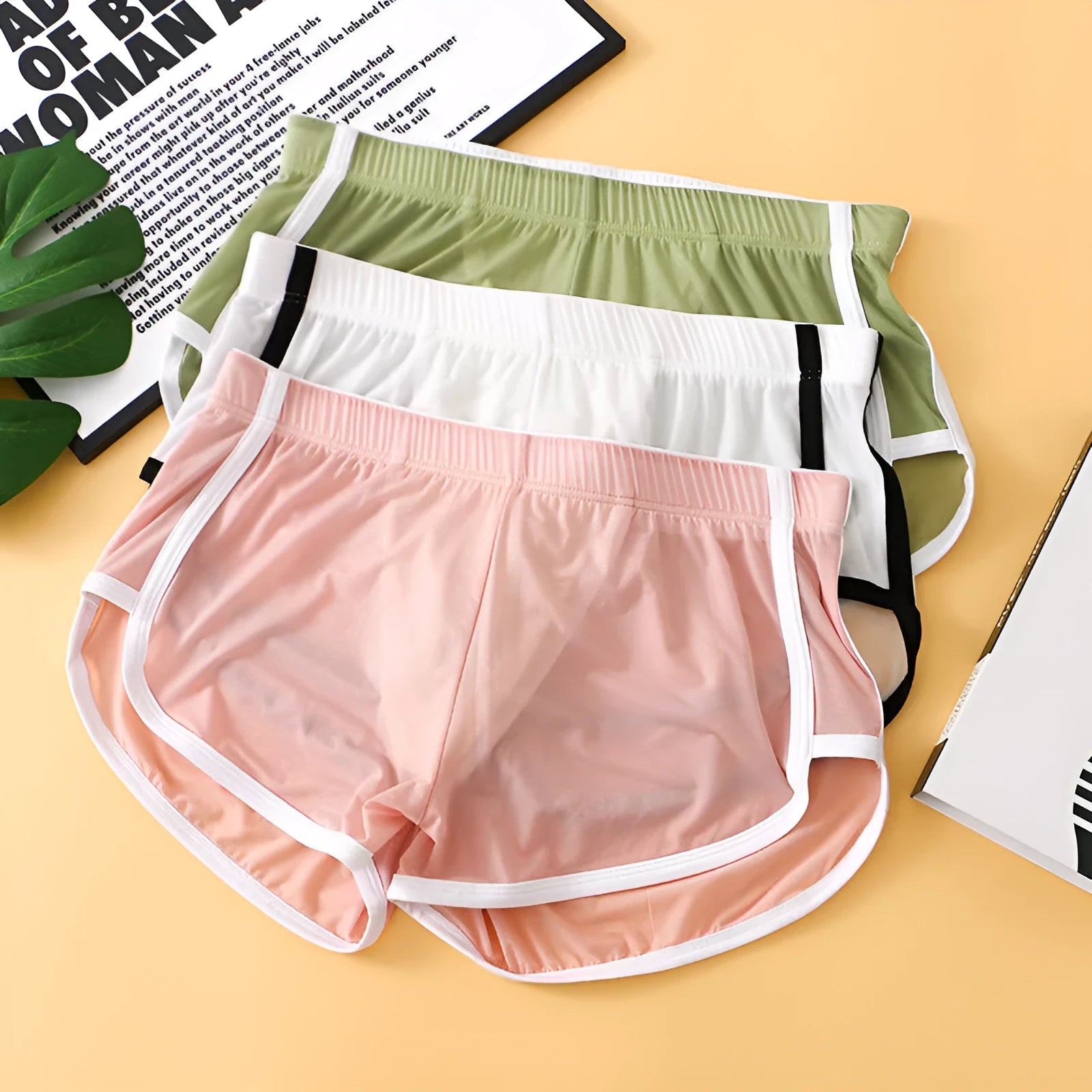 Men's ice silk mesh boxer shorts in a low waist design, shown in various colours including black, white, and army green.