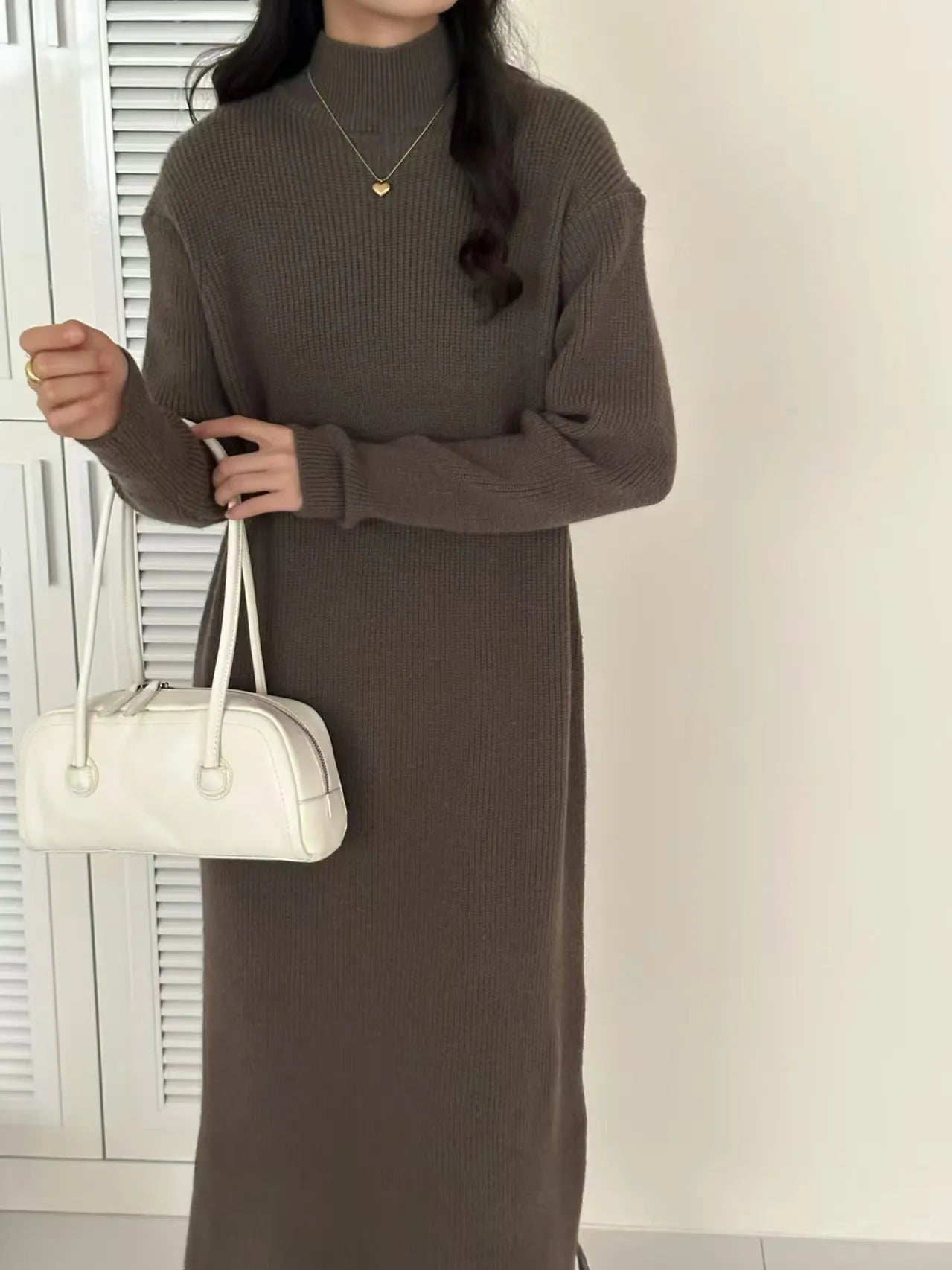 Acrylic knitted dress with half turtleneck, high waist, and midi length in solid colour