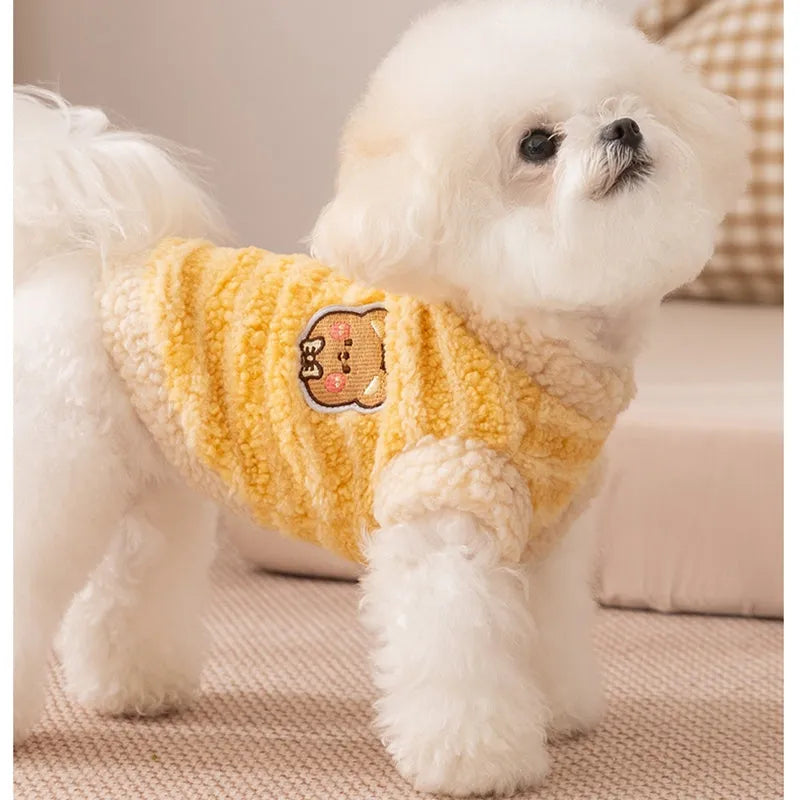 Yellow striped lambskin fleece dog clothing with bear patch and leash ring on a small dog