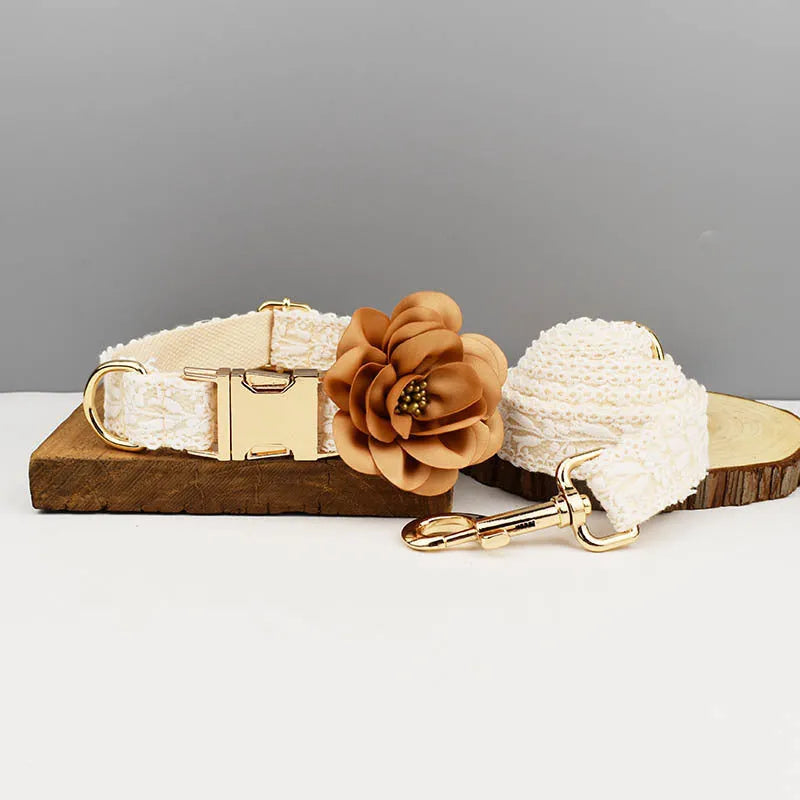 Four-piece dog wedding set with lace vest, matching collar, flower headband, and leash on white background