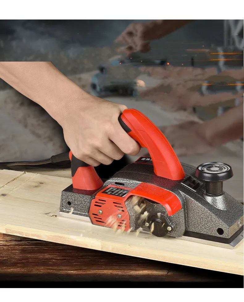 Red aluminium electric wood planer with 82mm width on workbench