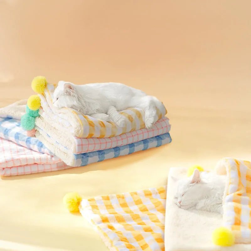 Blue coral fleece pet blanket shown in a large size on a wooden floor
