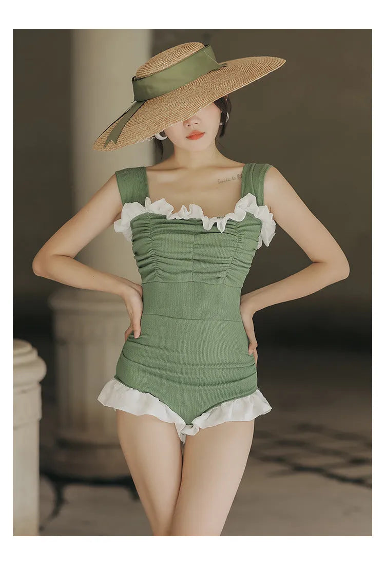 Women's black high-waisted one-piece triangle swimsuit, Korean style, on a mannequin.