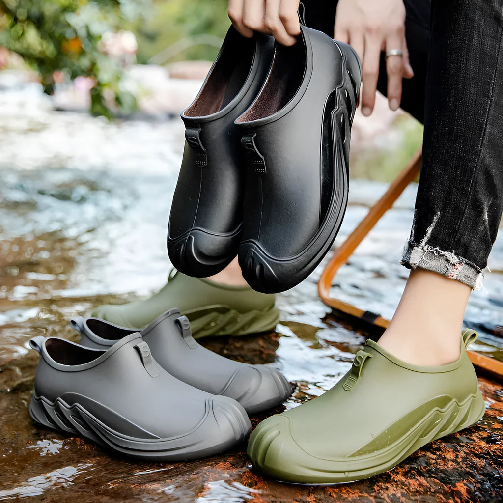 Men's black plastic rain boots showing short ankle height and solid colour design