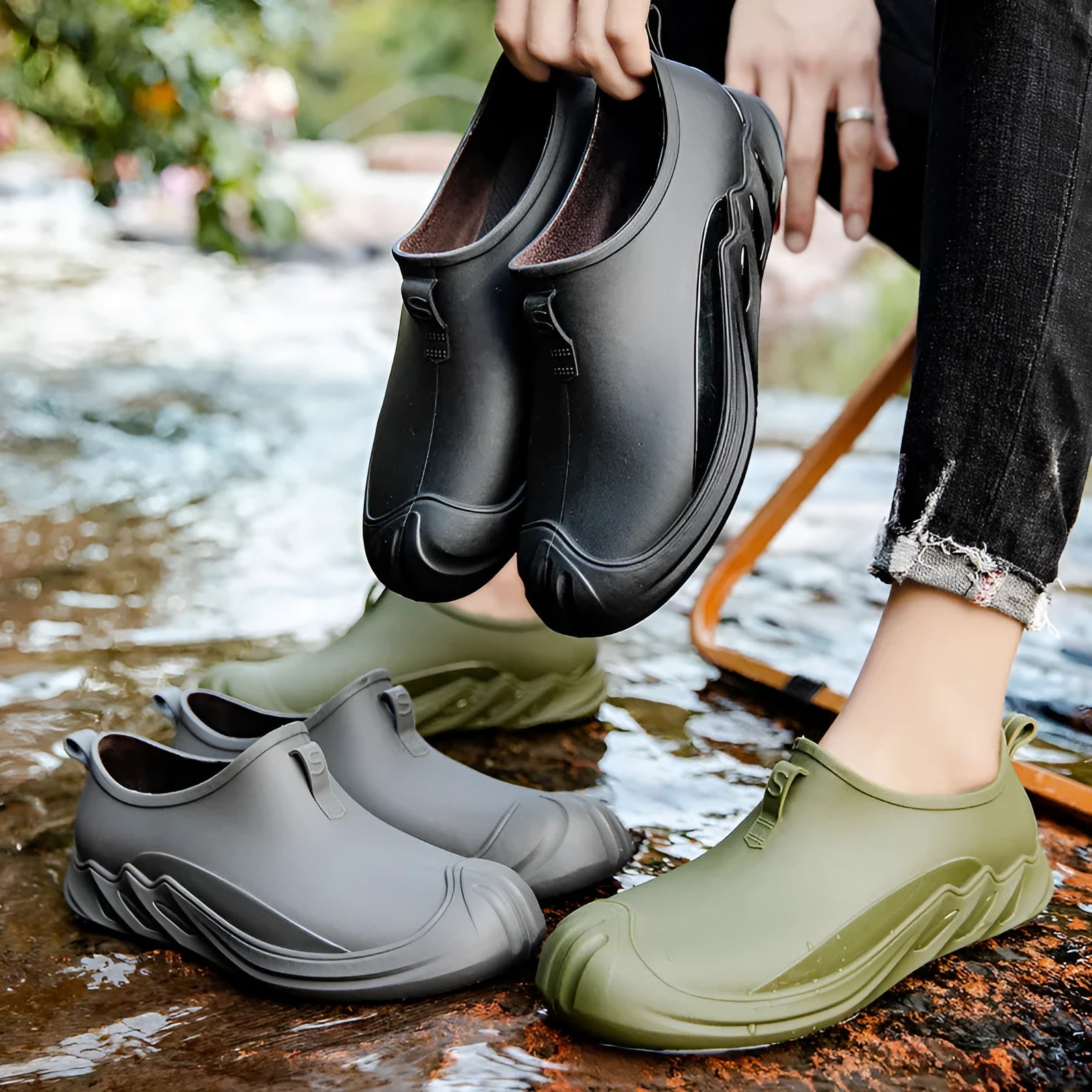Men's black plastic rain boots showing short ankle height and solid colour design