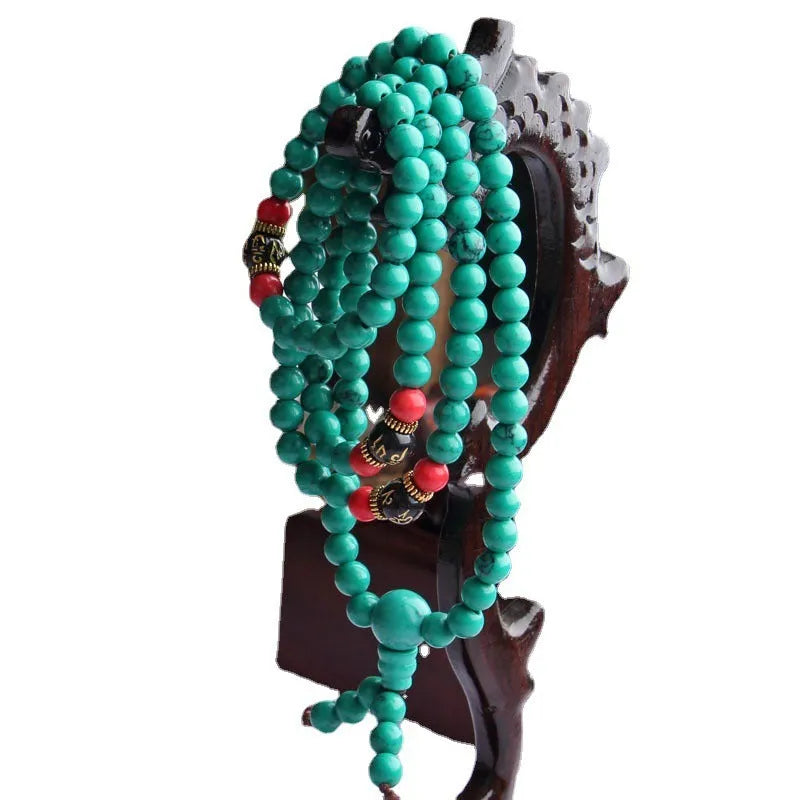 Turquoise-coloured 108 bead Buddhist Mala bracelet with round polished beads on adjustable string