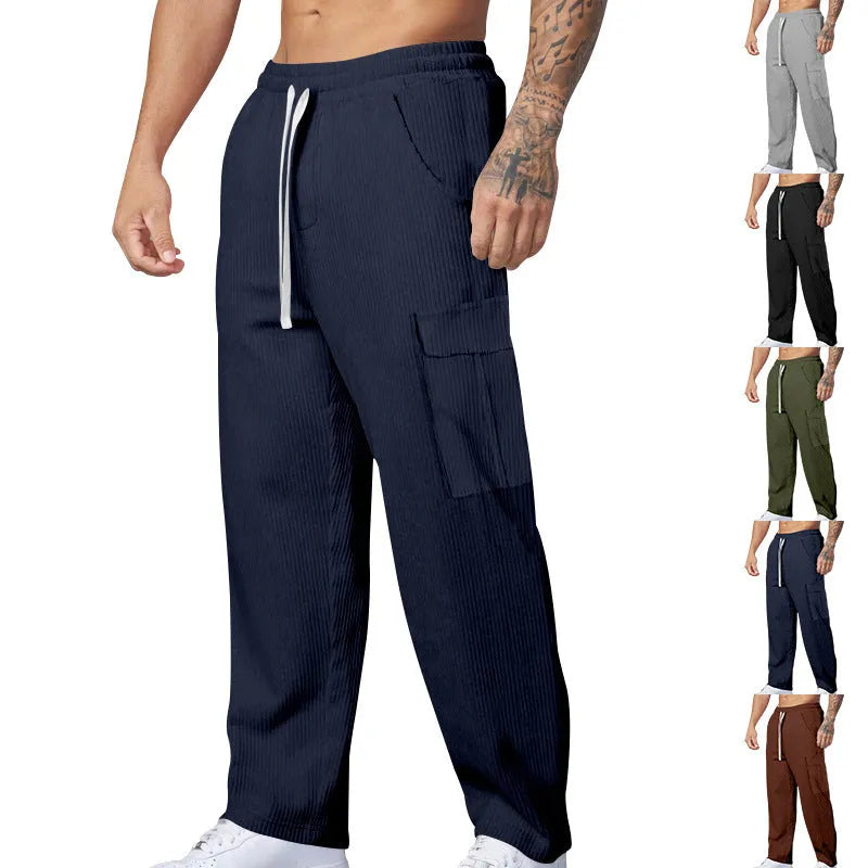 Men's navy blue corduroy wide-leg cargo trousers with a drawstring waist on a neutral background.
